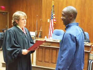 Jeffrey Baltimore, right, takes the oath of office as Harrisburg's newest City Council member.