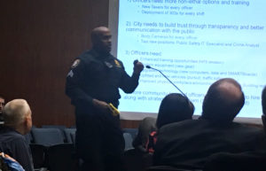 A Harrisburg police officer demonstrates a Taser at last night's city council meeting. 