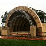 yellow-ish bandshell image. Ampetheater with a covered stage