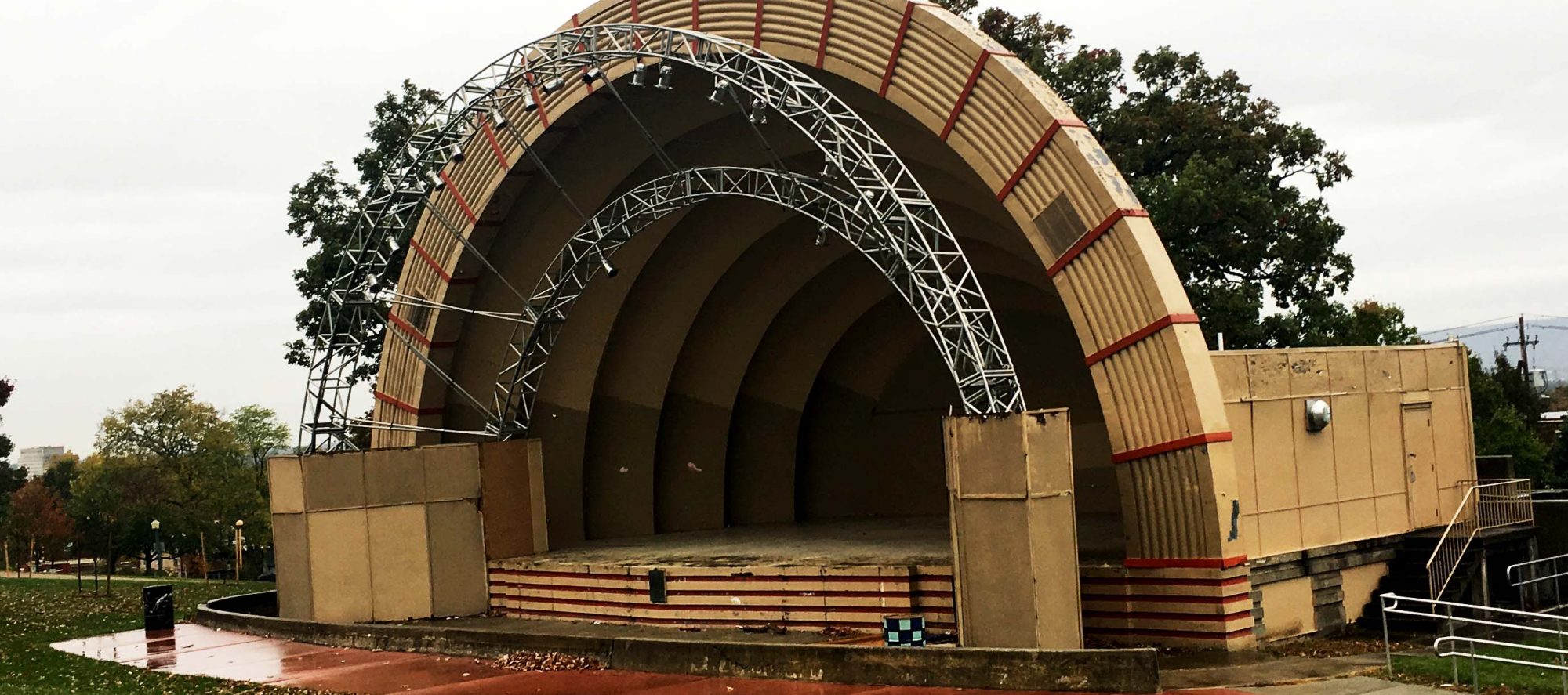 yellow-ish bandshell image. Ampetheater with a covered stage