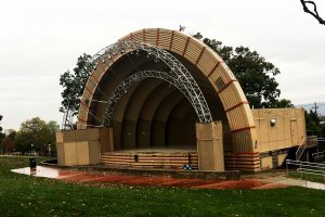 yellow-ish bandshell image. Ampetheater with a covered stage
